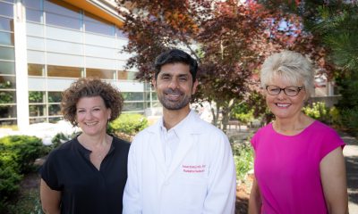Three PeaceHealth cancer center caregivers pose outside of hospital