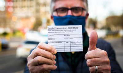 Man holds COVID-19 vaccine card