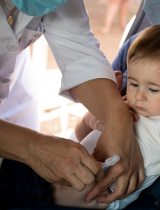 A child receives a vaccination from a healthcare provider