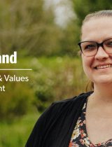 Image of Tina Noland outside in front of green bushes