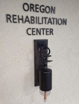 Oregon Rehabilitation Center sign and bell that patients ring when they complete their recovery from illness or injury.