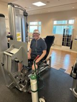 Bret using an exercise machine at peacehealth sacred heart at riverbend