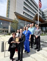 The American Heart Association presenting a plaque on the steps of Southwest Washington Medical Center, celebrating PeaceHealth's 50 years of membership with the AHA.