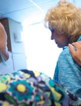 Nurse providing comfort to a female patient