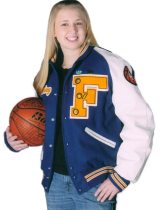 In a letterman's jacket, Chelsey Ebert smiles while holding a basketball.