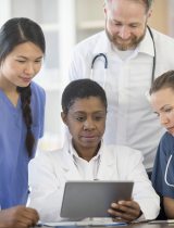 A group of providers reading a chart