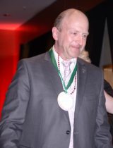 A man with a medal on his neck walking