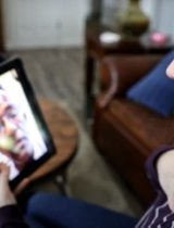 Woman talks with a doctor using her tablet
