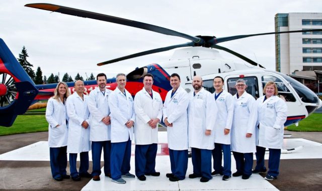 Southwest Medical Center Trauma Surgeons stand in front of their helicopter
