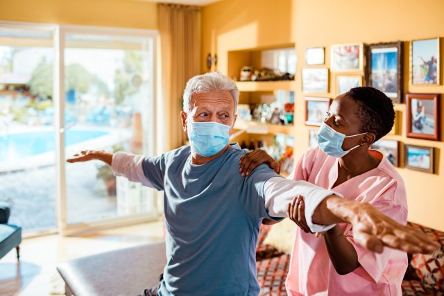 Home Health nurse helping patient at home