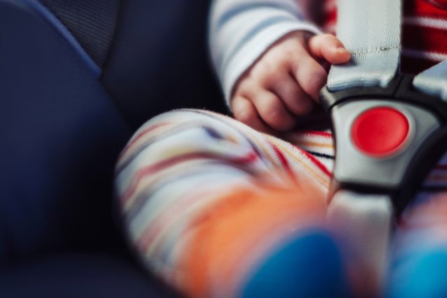 Close-up of baby buckled into a car seat