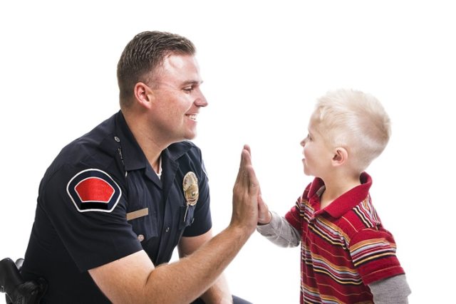Security officer high fives young boy