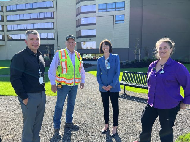 Construction and clinical leaders stand in new green space at PeaceHealth Sacred Heart Medical Center, University District