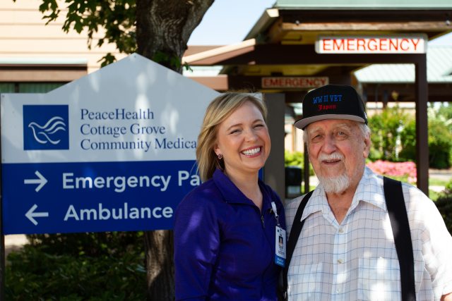 PeaceHealth nurse stands with smiling patient in front of Cottage Grove ER