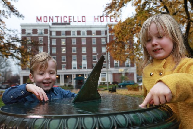 Two children enjoy the fountain in front of the Monticello Hotel in Longview
