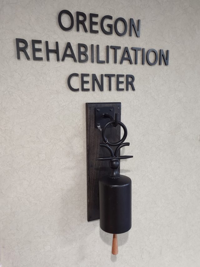 Oregon Rehabilitation Center sign and bell that patients ring when they complete their recovery from illness or injury.