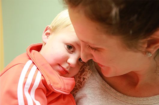 A mother holds her child close to her