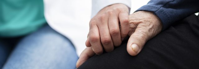 Two people clasp hands
