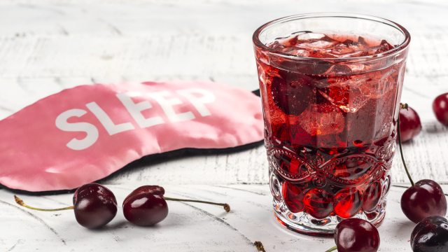 Sleep mask sits next to cherry drink