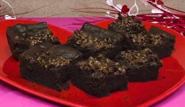 Close-up of plate of squares of brownies with chocolate chips on top
