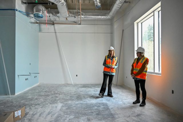 Alicia Beymer, chief administrative officer at RiverBend hospital (left) and Ashley McDonald, CEO of PeaceHealth's new inpatient rehabilitation facility, describe construction status, goals and plans for the new facility