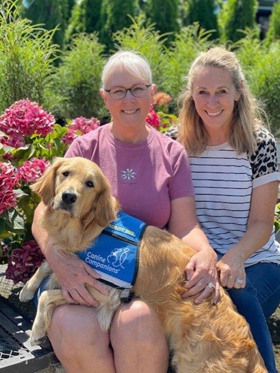 Lilikoi, a golden retriever, with Nancy Rice and Kim Blatz