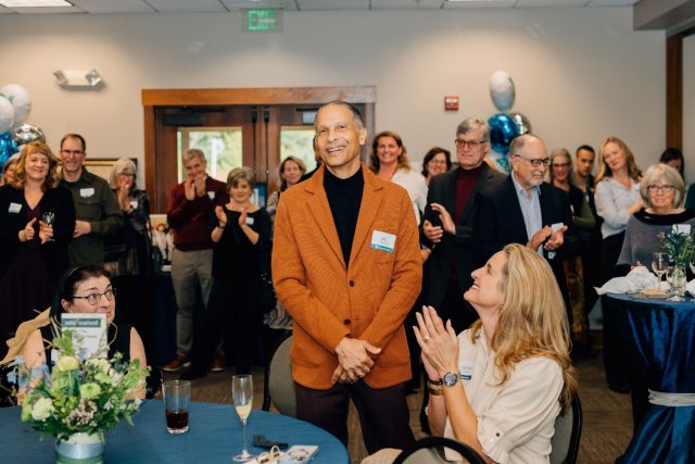 Dr James M Douglas Jr smiling at the camera during his retirement party