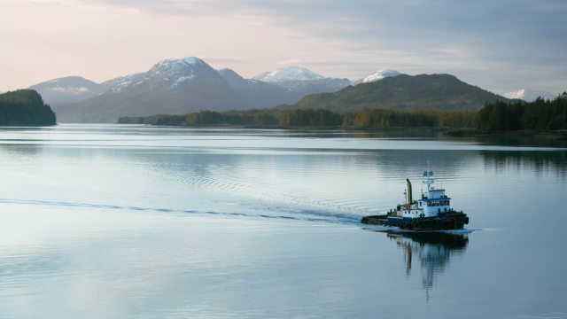 Small tugboat crossing calm water in Ketchikan, Alaska 