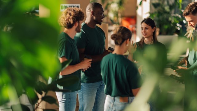 Volunteers gather at a workstation