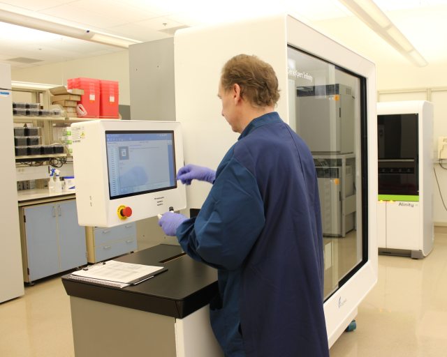 A caregiver uses a piece of lab equipment to test a specimen at the RiverBend Annex.