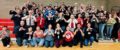 North Eugene High School student group picture with all holding hands in a heart shape