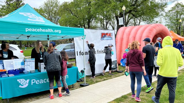 Volunteers and participants gather at a PeaceHealth community event