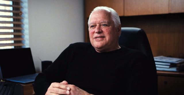 John Huntley sitting at a desk