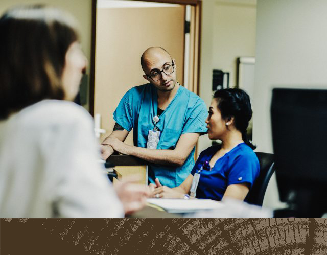 Caregivers at a front desk in a discussion
