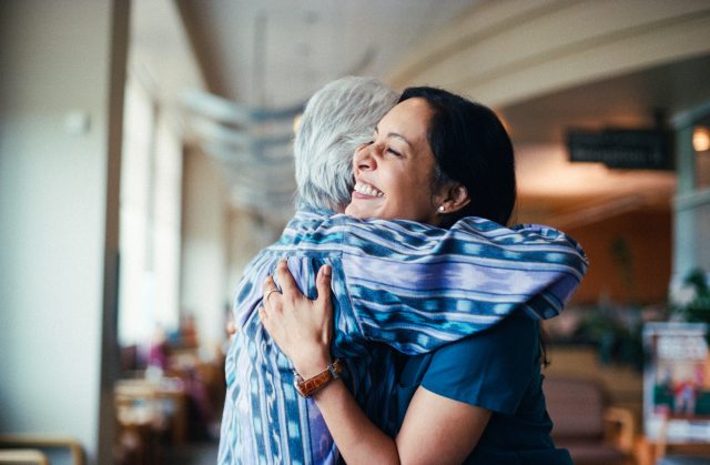 PeaceHealth's Dr. Banerjee smiles and hugs a patient 