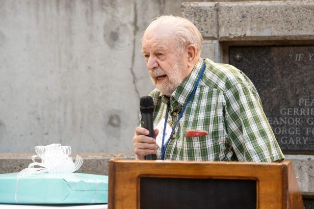 Dr. Richard Nau speaking to a crowd from a lectern