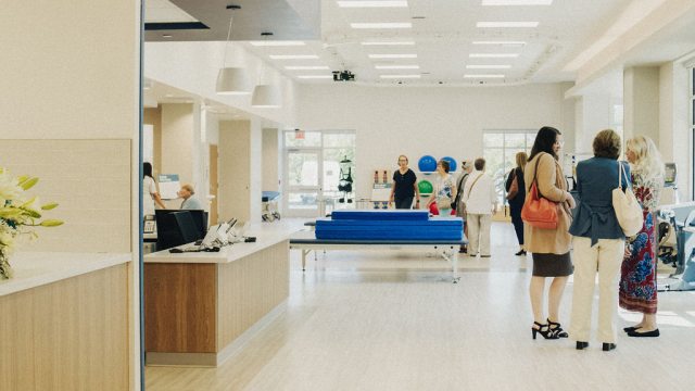 People walk through the gym for physical therapy in the inpatient rehabilitation center.