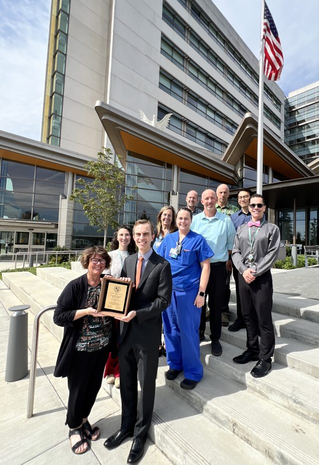 The American Heart Association presenting a plaque on the steps of Southwest Washington Medical Center, celebrating PeaceHealth's 50 years of membership with the AHA.