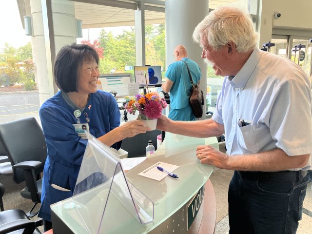 Eric delivers a Cuppa Cheer to volunteer Melissa
