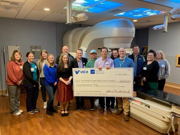 Veca presenting a check to United General's cancer center