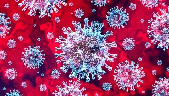 Blue tinted coronavirus cells floating in a background of red 
