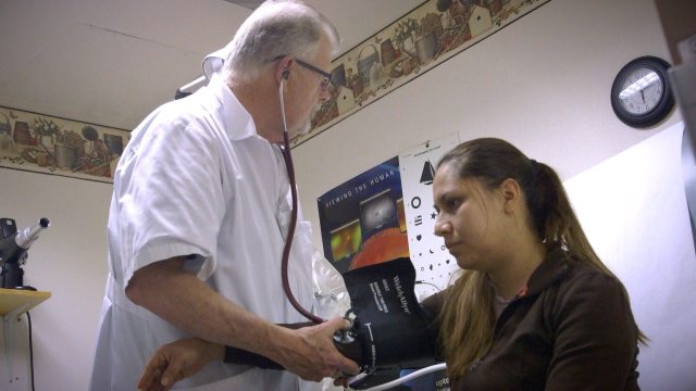 A provider checks a patient's blood pressure at the free clinic of SouthWest Washington