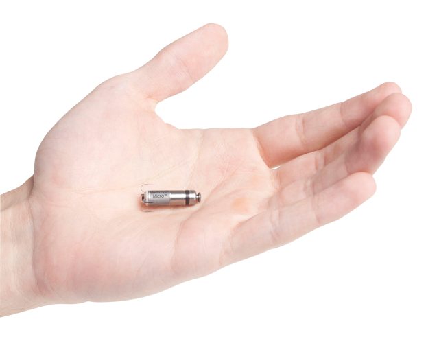 Close-up of hand holding a tiny micra device
