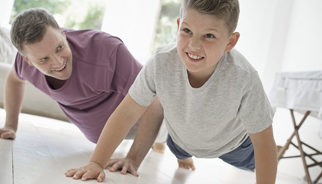 Father and son do push-ups together