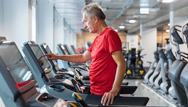 Man preparing to start walking on treadmill
