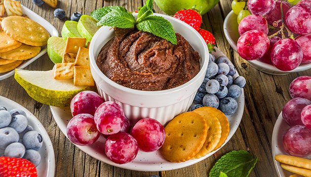Snickerdoodle dip with fruit and other items to dip