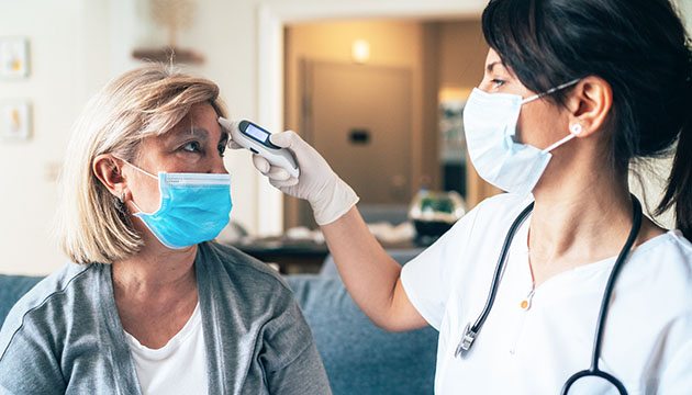 nurse and patient wearing masks during a visit