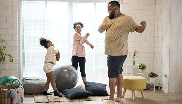 Father exercises with young daughters