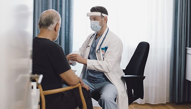Doctor talks to a man in an exam room