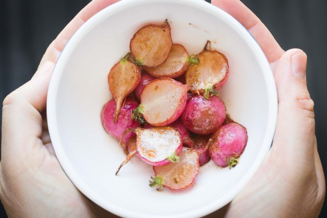 Bowl of red potatoes garnished with an herb